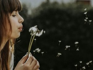 how to stop negative thoughts transmute them girl blowing dandelion